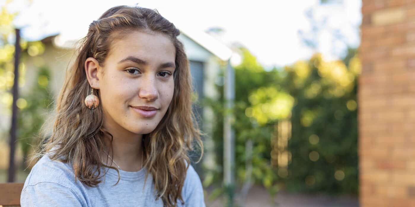 Portrait of a Happy Teenage Maori Girl Smiling in the Backyard