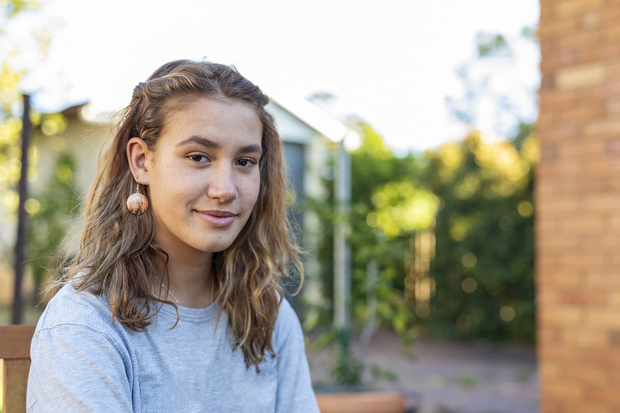 Portrait of a Happy Teenage Maori Girl Smiling in the Backyard