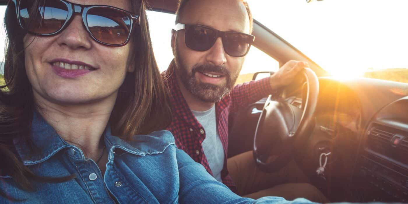 Photo of the couple traveling in the car taking selfie