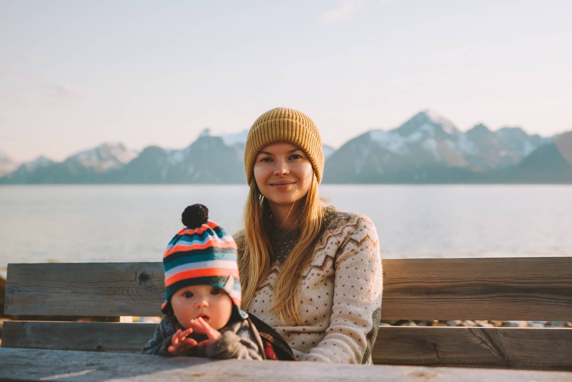 Mother traveling with baby in Norway relaxing enjoying mountains view family vacation mom and child active healthy lifestyle outdoor