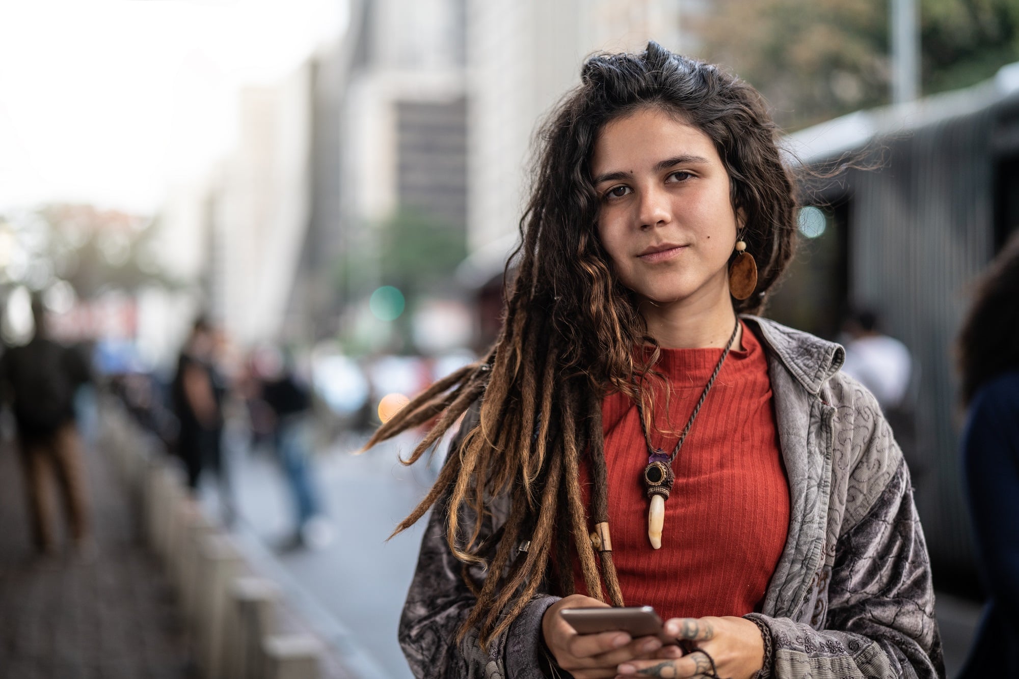 Hippie Young Woman Using her Smartphone in the City