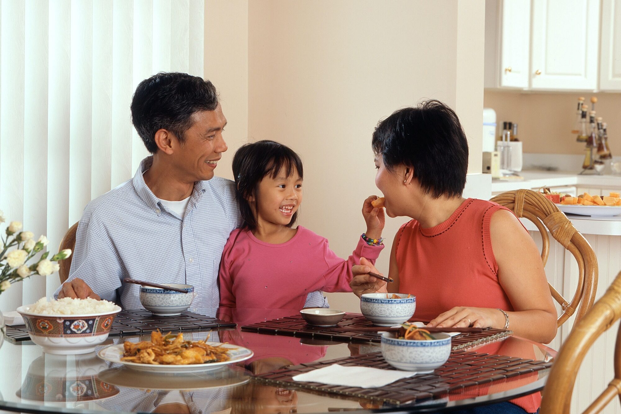 A family share a meal together.