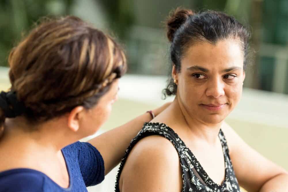 Two woman supporting each other